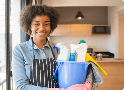 image of a woman holding cleaning supplies