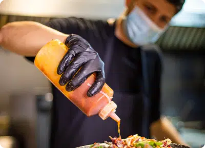 image of a man pouring sauce