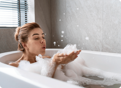 image of woman having a bubble bath