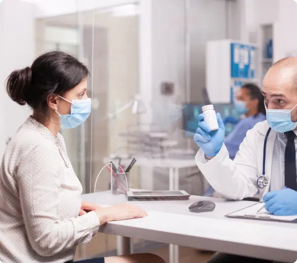 image of a doctor handing over a pill bottle to a patient