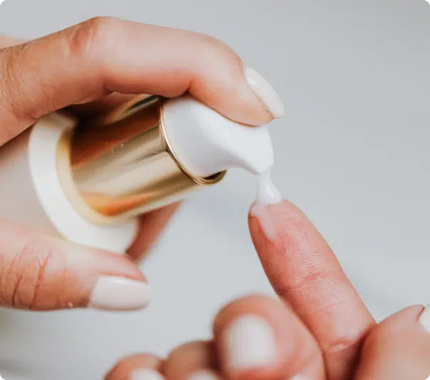 putting lotion into a finger from a Plastic Lotion Pump Bottle
