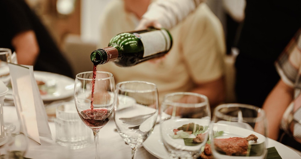 Image of pouring wine to wine glasses