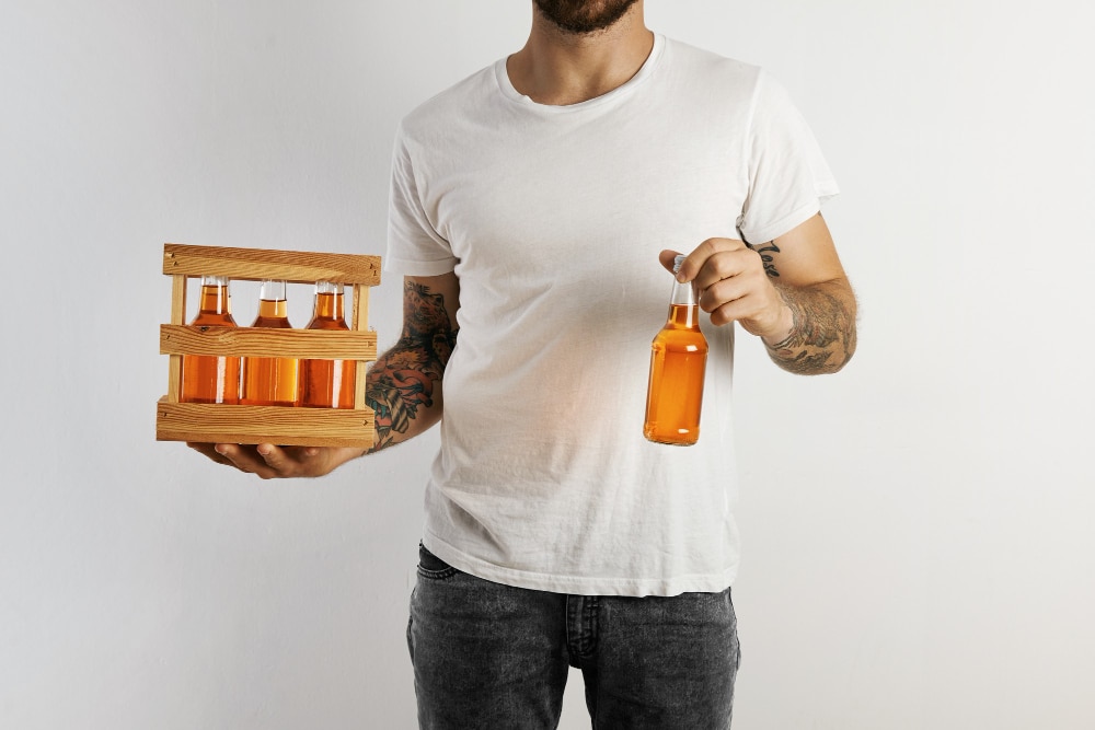 Image of a man holding plastic beverages bottles in hand