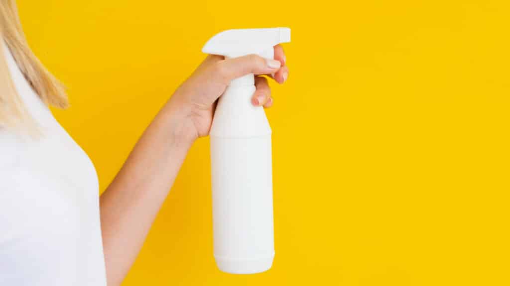 Image of a plastic spray bottle in hand