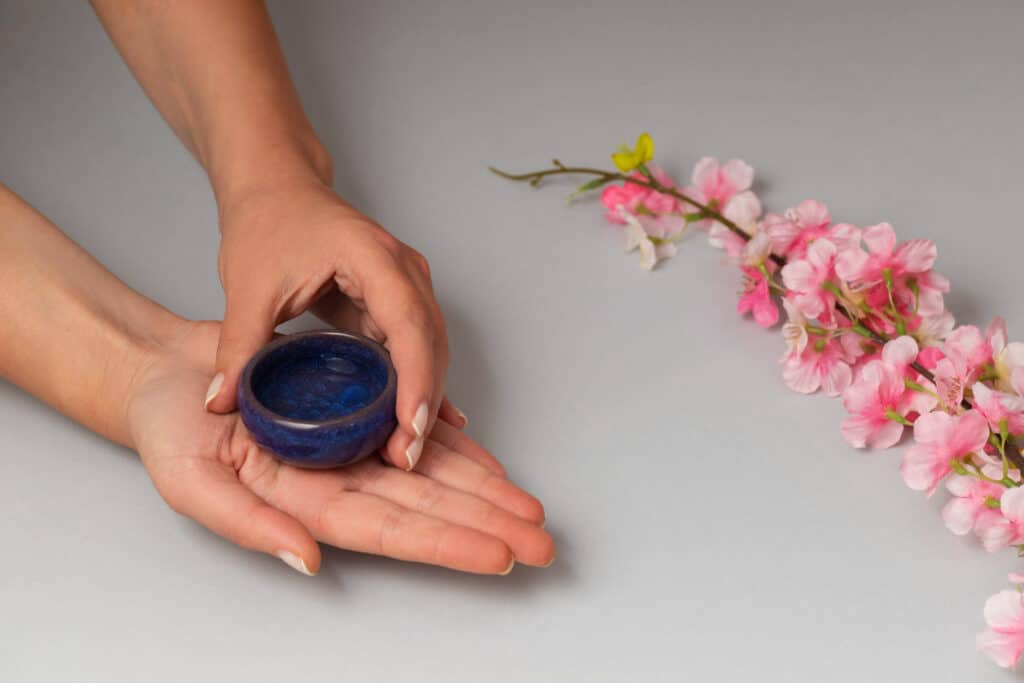 Image of a cosmetic jar in hand