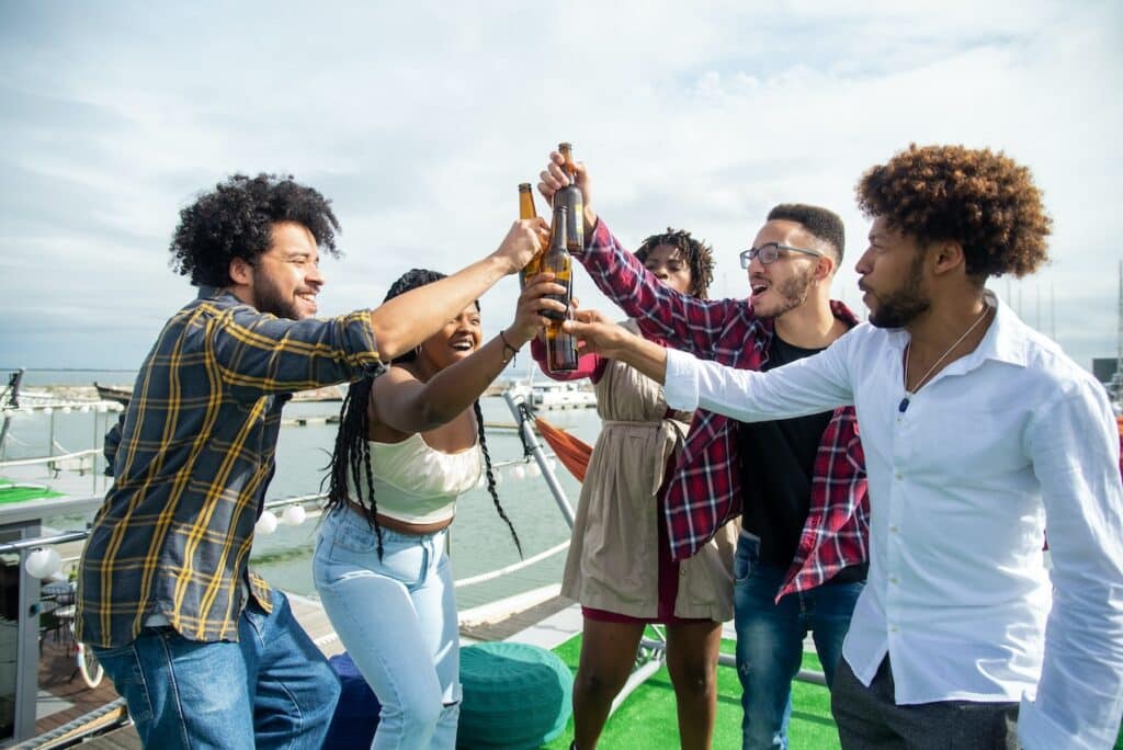 Image of a group of people celebrating with glass bottles