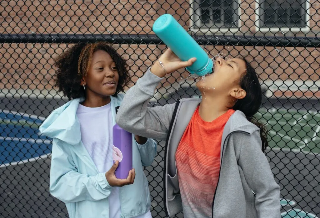 Image of a girl drinking from a plastic bottle