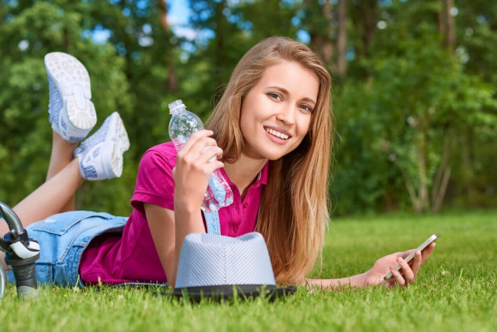Image of a young woman with a water bottle in hand