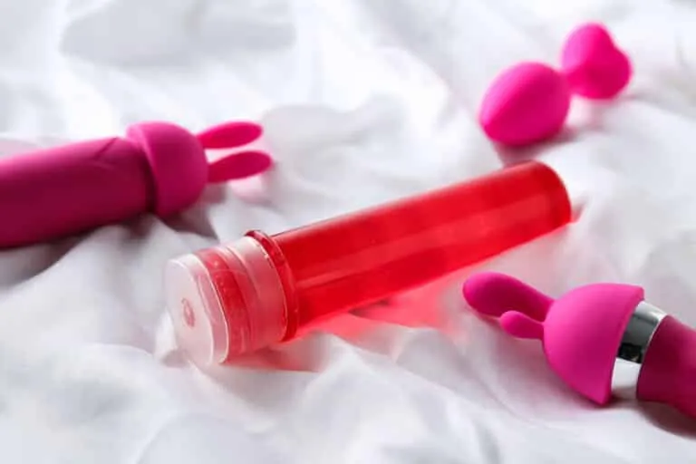 an image of a big bottle of lubricants near toys