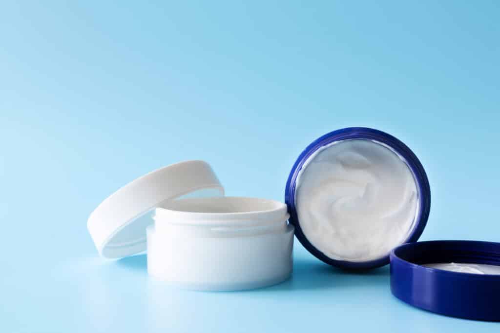 an image of two plastic jars with moisturizer cream.