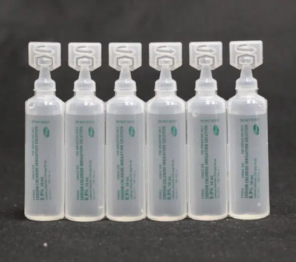 plastic eye droppers in a black background