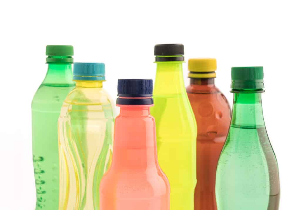 12 oz Plastic Bottles with Caps with soft drink on white background
