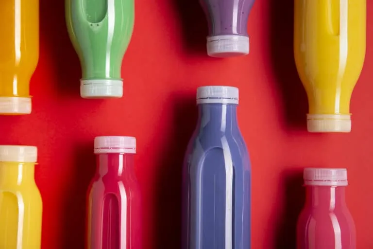 colorful 16 oz Plastic Bottles on a red background
