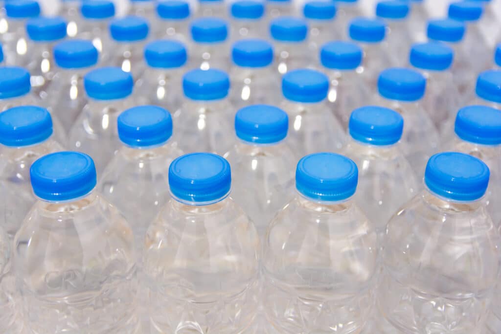 Row of Blank Water Bottles. Bottles with blue caps For drinking water