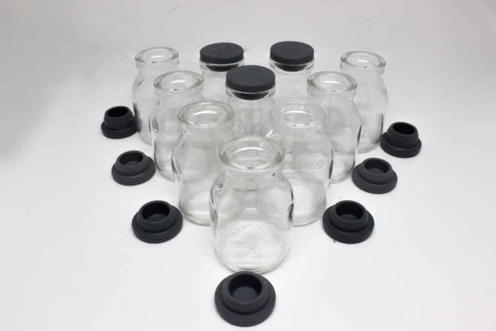 clear plastic bottles with caps on a white surface
