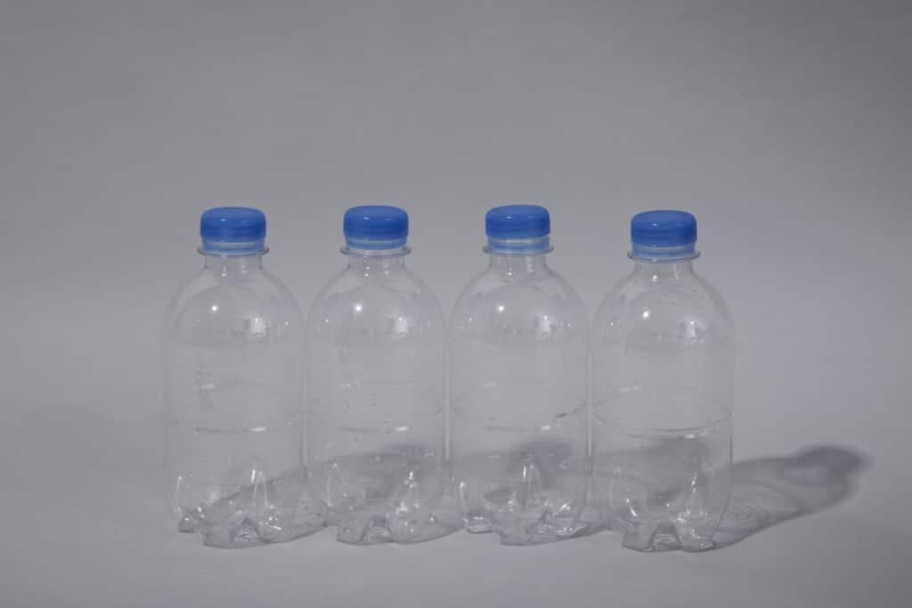 clear plastic bottles with caps in a white background