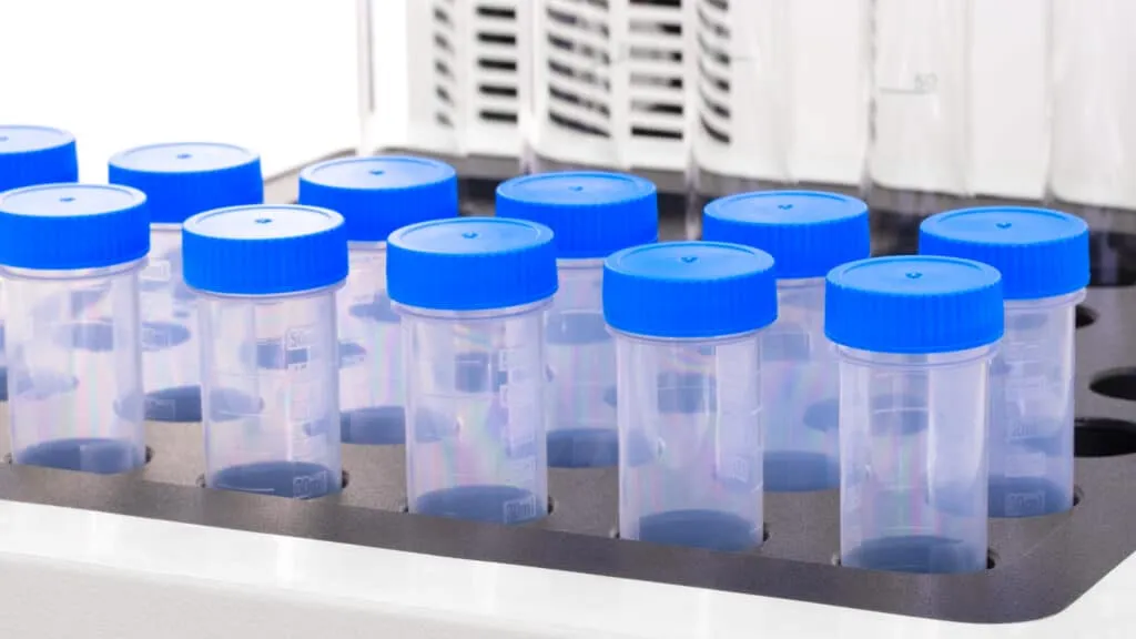 Medical or chemical background with laboratory equipment and liquids.