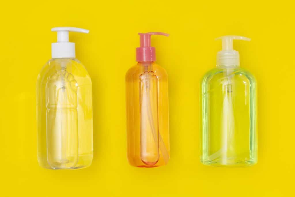 16 oz plastic bottle sanitizers on a yellow surface