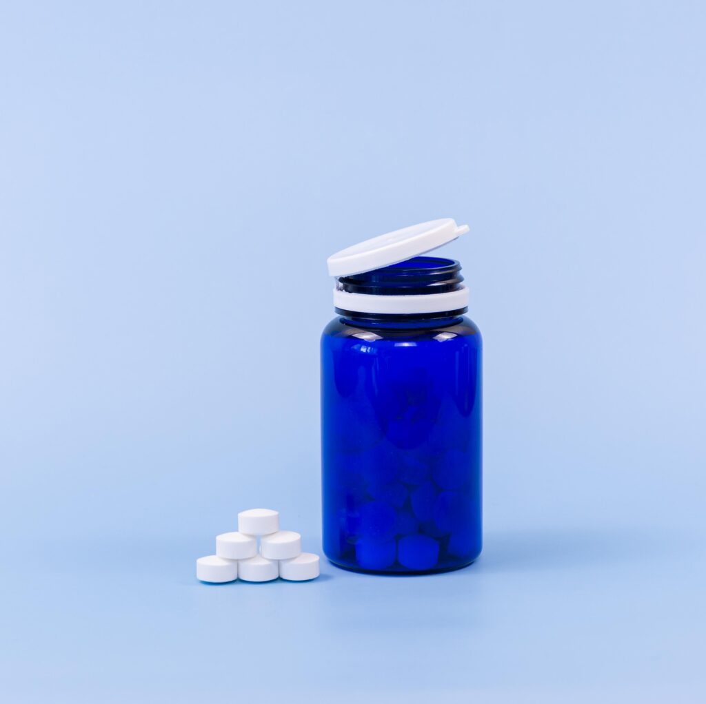 dark blue color wholesale pill bottle in a blue background