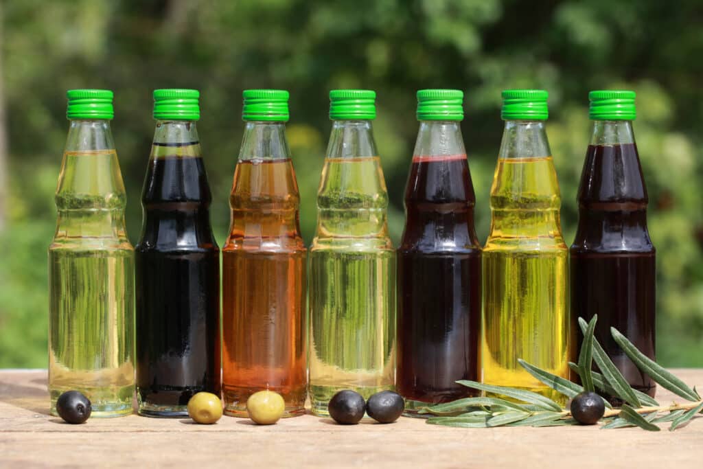 Different types of  Olive Oil in Plastic Bottles in on a wooden table