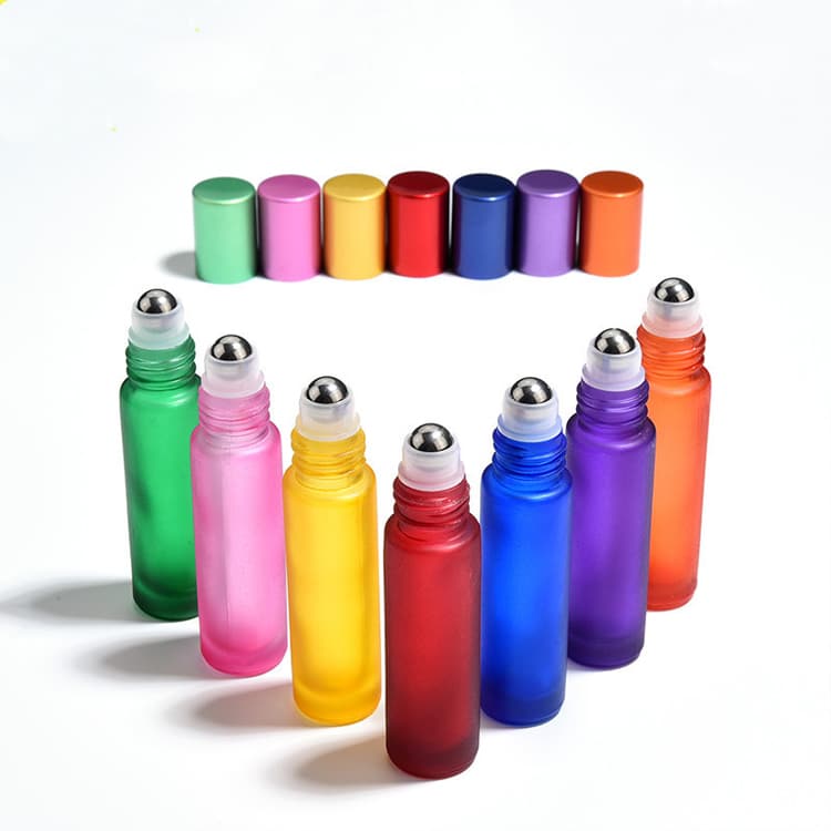 Colorful roll-on bottles lined up in a row, with their matching caps displayed behind them.