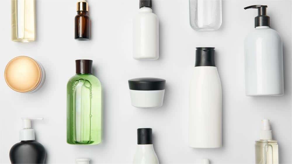 An assortment of cosmetic bottles in different shapes and sizes, showcasing packaging options for beauty products.