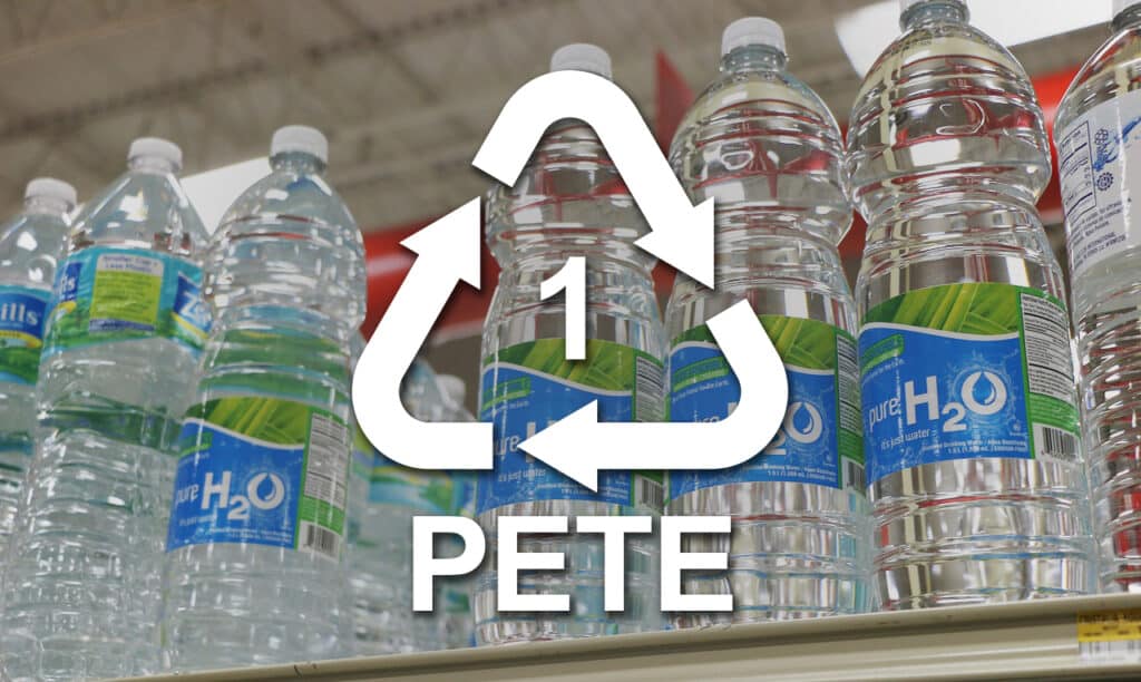 PETE plastic bottles with recycling symbol on a store shelf.