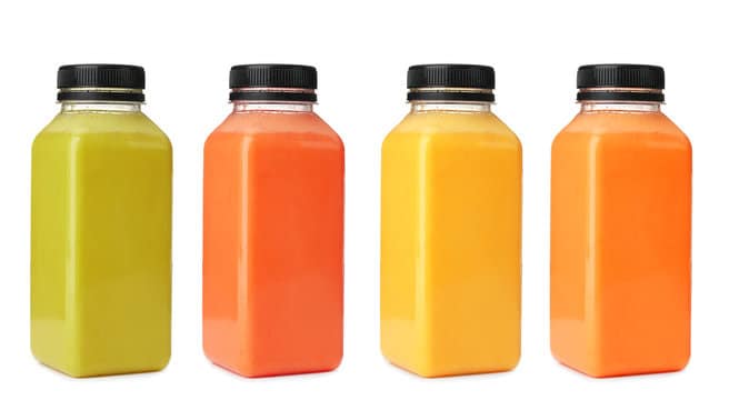 Colourful juice bottles on a white background