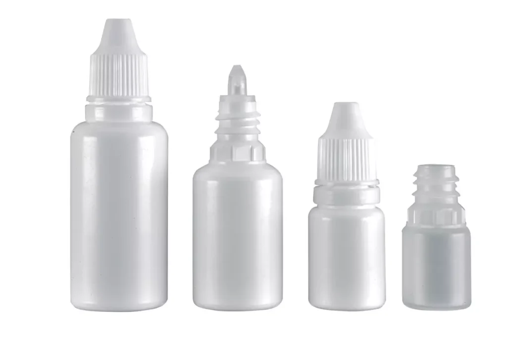 A collection of white plastic dropper bottles