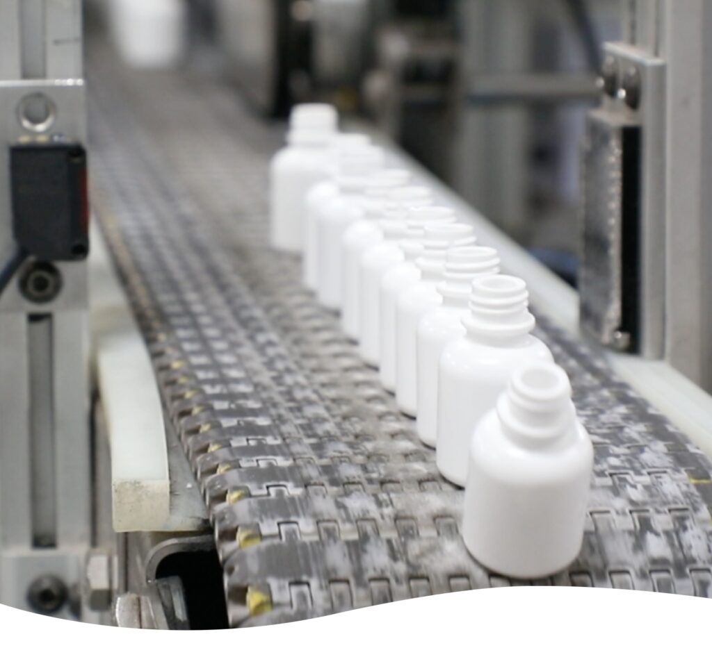 Production line of plastic dropper bottles on a conveyor belt