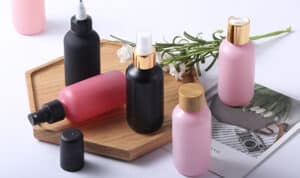 A variety of skincare bottles displayed on a wooden tray