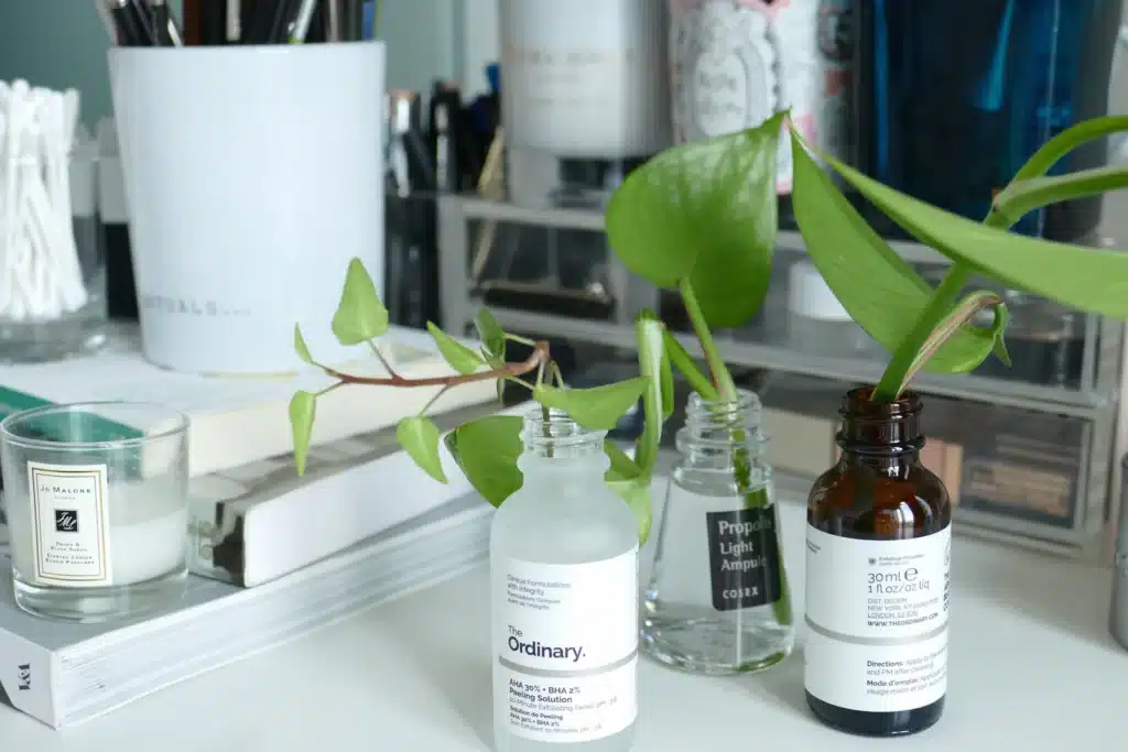 Empty serum bottles repurposed as vases for plant cuttings