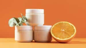 white color Plastic Cosmetics Jars in an orange background