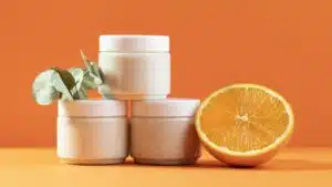 white color Plastic Cosmetics Jars in an orange background