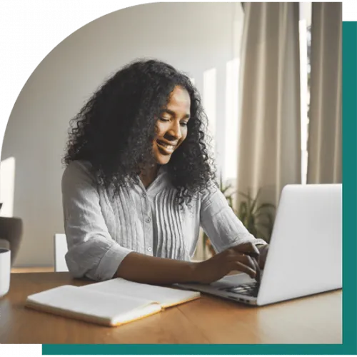 image of a black woman typing on her laptop